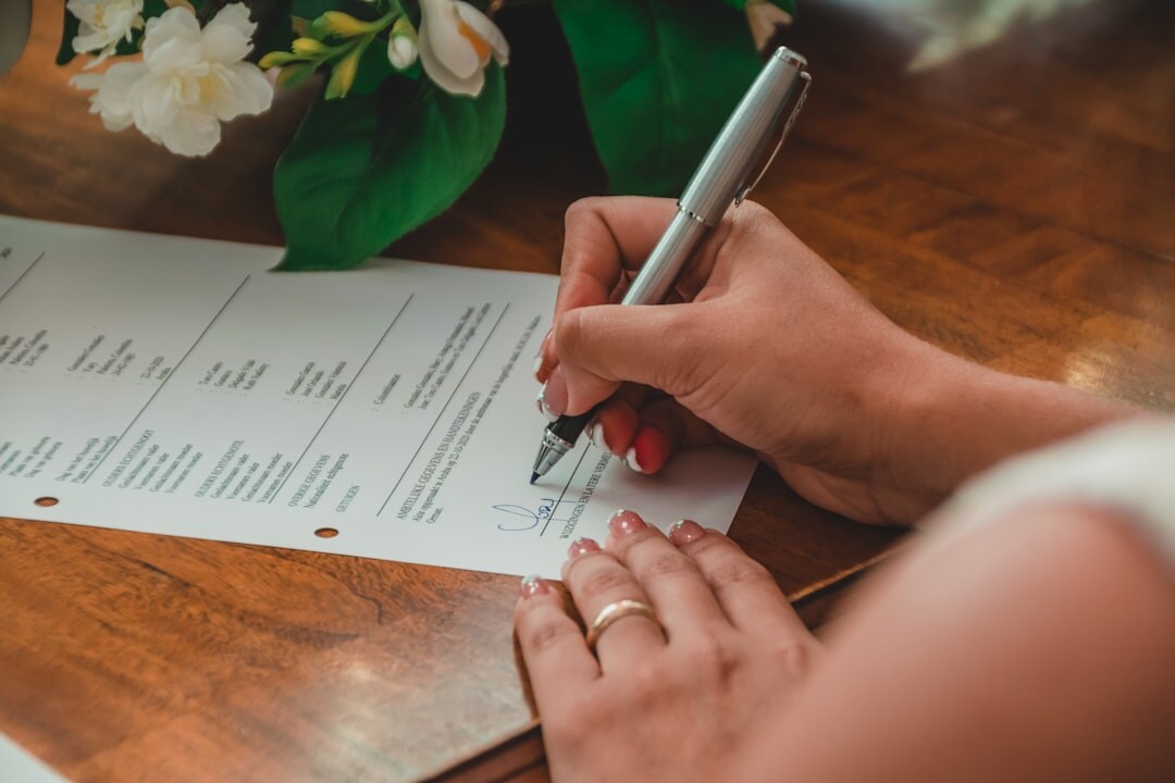 Close up of hands signing a last will and testament document